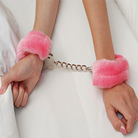 Womans arms with handcuffs on